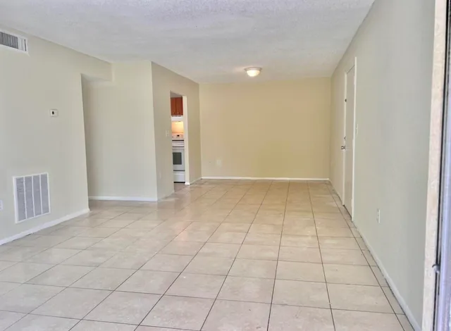an empty room with white walls and tiles