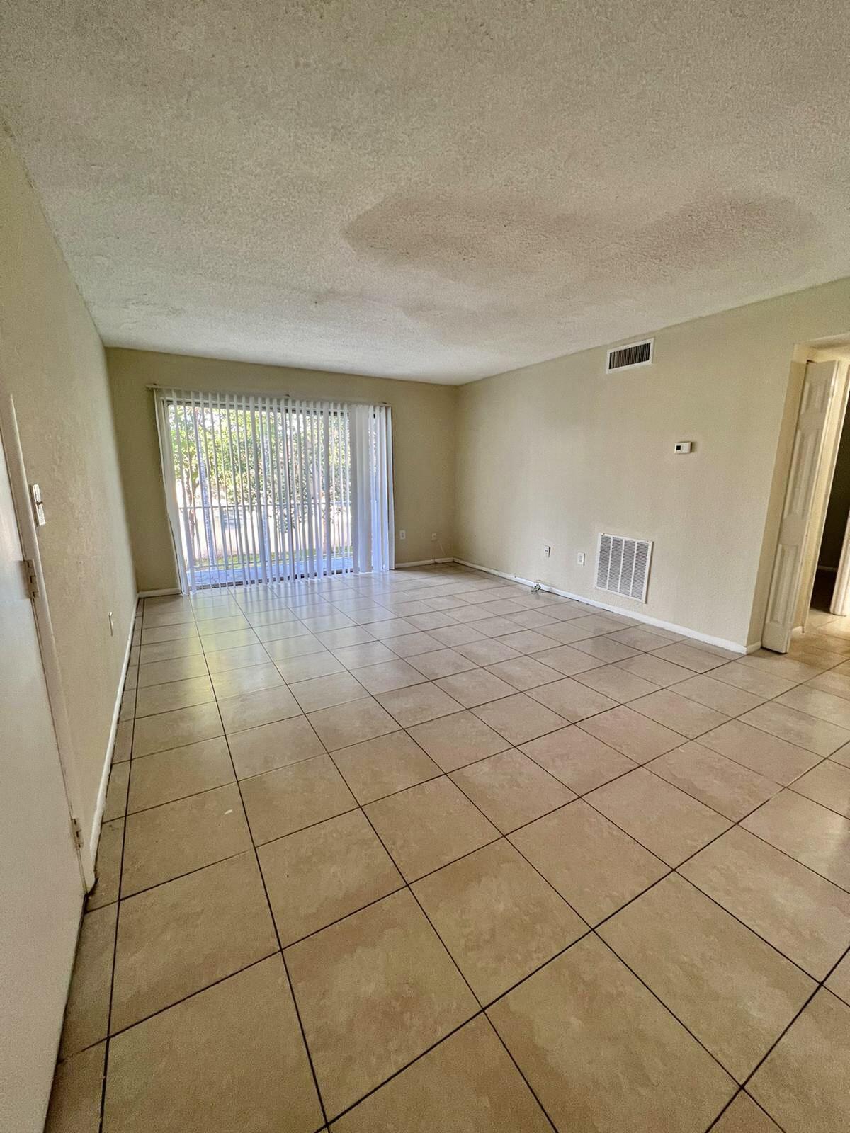 415 Executive Center Drive, Unit 213 West Palm Beach, FL 33401 - Photo 7 of 23 a view of an empty room and window