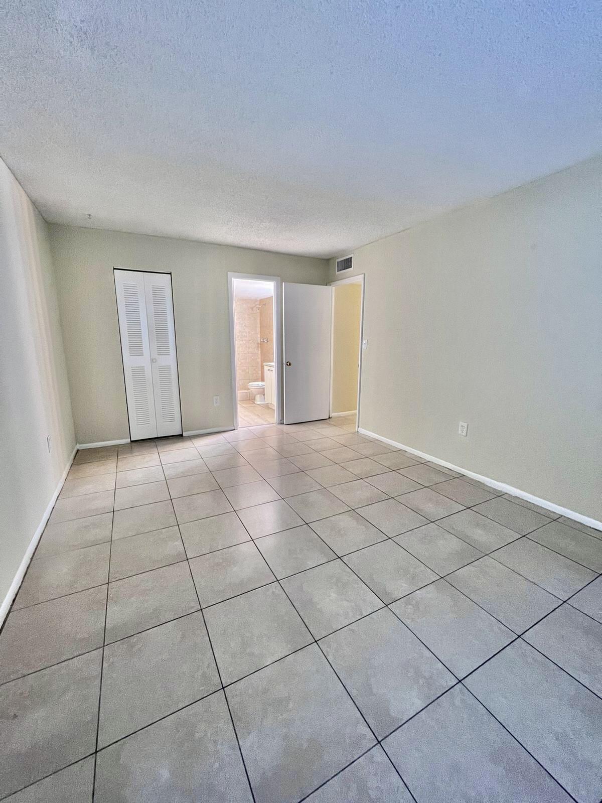 415 Executive Center Drive, Unit 213 West Palm Beach, FL 33401 - Photo 10 of 23 a view of an empty room and window