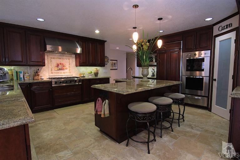 1320 Rambling Road Simi Valley, CA 93065 - Photo 1 of 3 a kitchen with granite countertop a sink refrigerator and cabinets