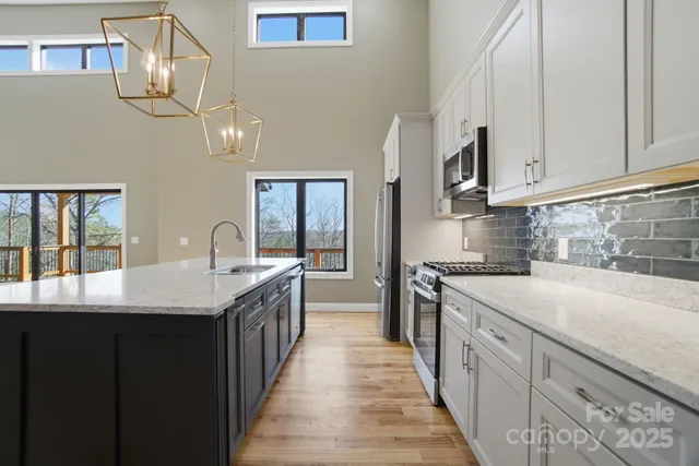 a view of a room with wooden floor and a ceiling fan