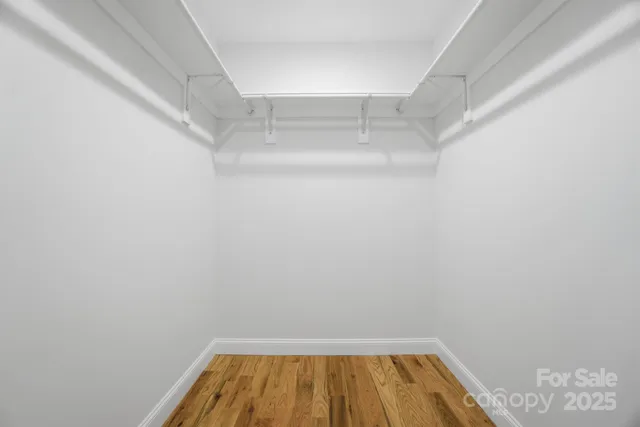 a view of a room with wooden floor and empty space