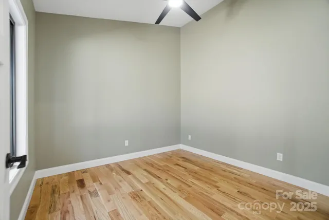 a view of a hallway view with wooden floor and staircase