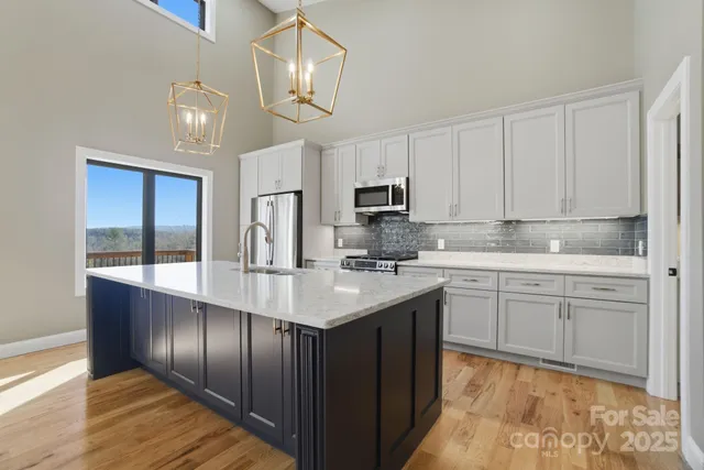 a view of a house with a yard balcony and wooden floor