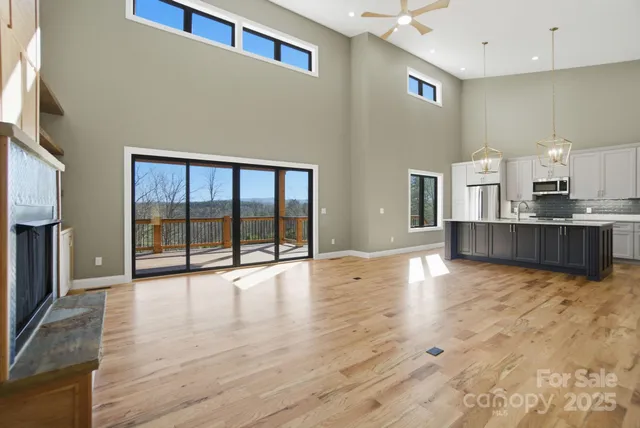 a living room with fireplace furniture and a floor to ceiling window