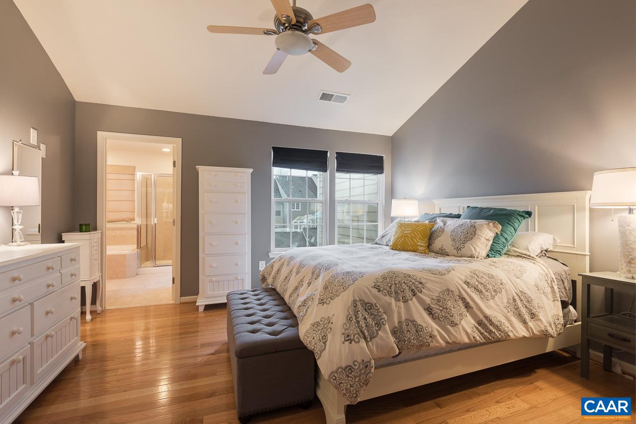 711 Rainier Road Charlottesville, VA 22903 - Photo 14 of 17 a bedroom with a large bed and a chandelier