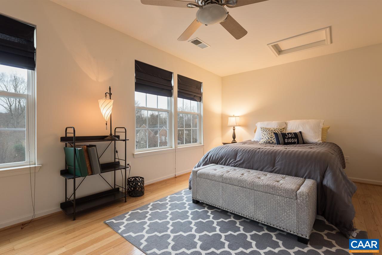 711 Rainier Road Charlottesville, VA 22903 - Photo 16 of 17 a bedroom with a bed and wooden floor