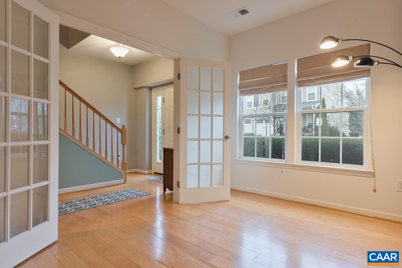 711 Rainier Road Charlottesville, VA 22903 - Photo 2 of 17 a view of an empty room with a window and wooden floor