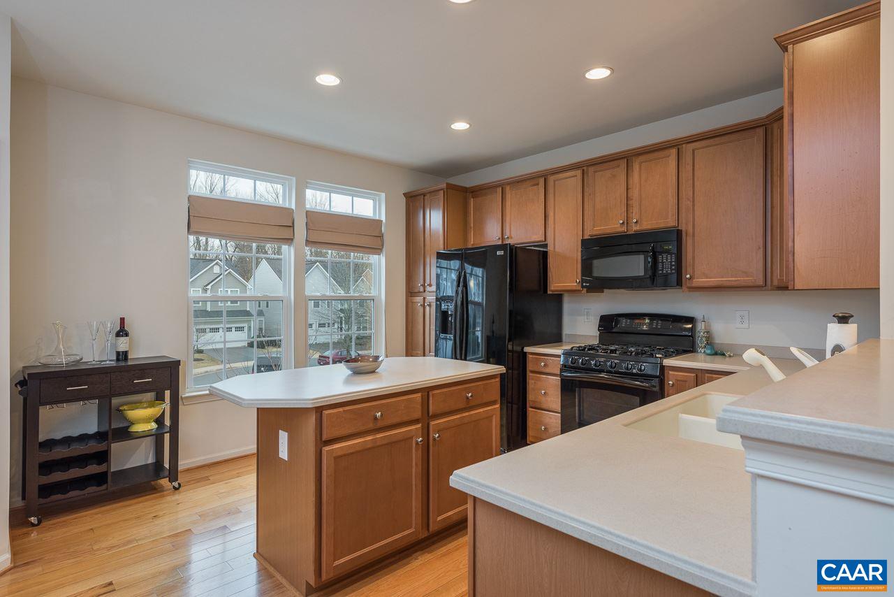 711 Rainier Road Charlottesville, VA 22903 - Photo 7 of 17 a kitchen with a sink a counter top space stainless steel appliances and cabinets