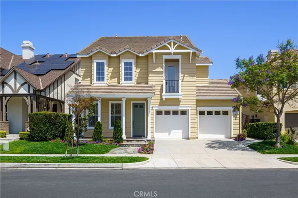 a front view of a house with a garden and plants