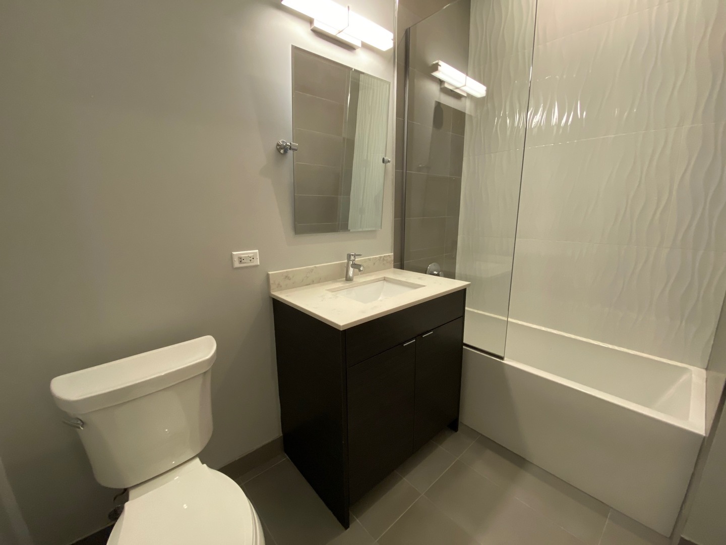 Undisclosed Address Chicago, IL 60612 - Photo 9 of 16 a bathroom with a sink vanity mirror and toilet