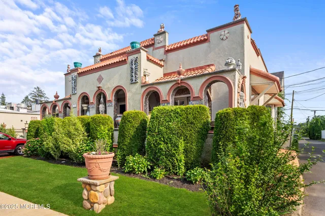 a front view of a house with a garden