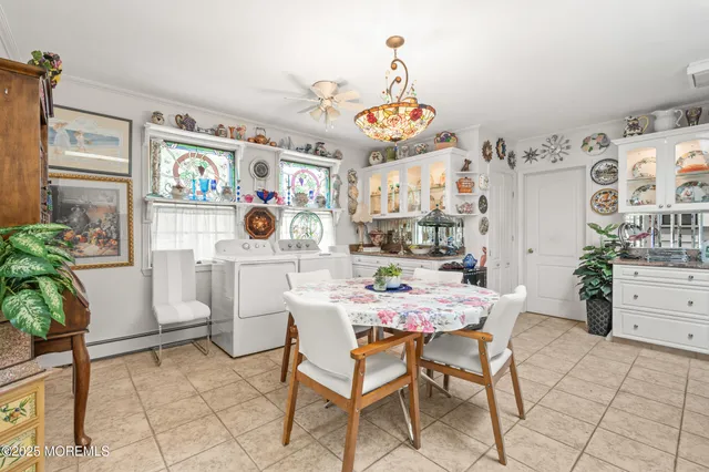 a view of a dining room with furniture and chandelier