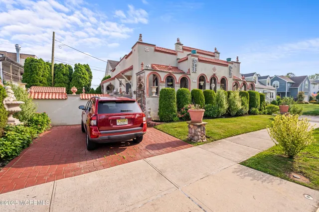 a car parked in front of a brick house with a yard