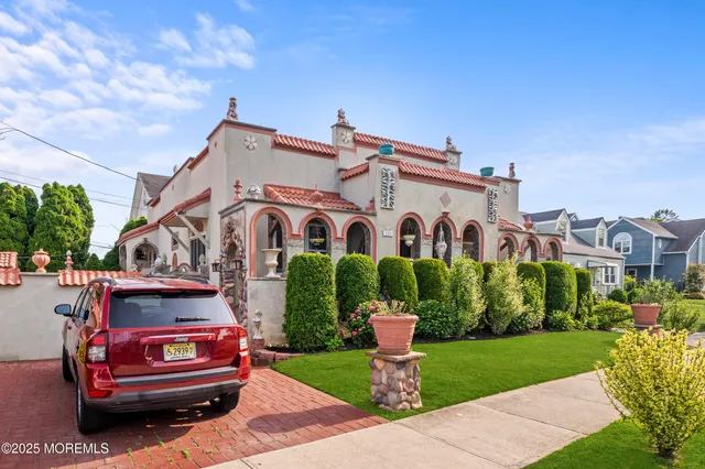 a front view of a house with a garden