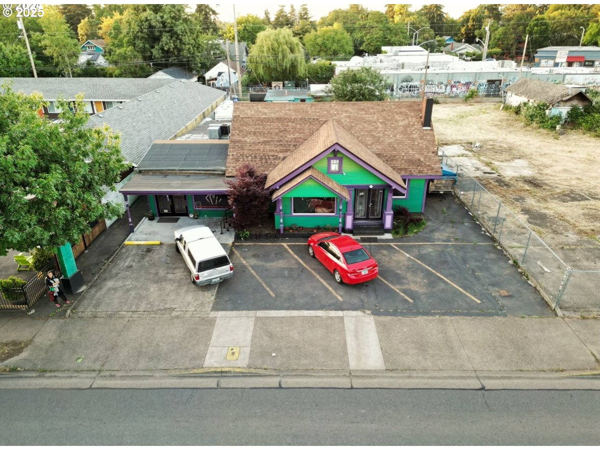 1030 West 5th Avenue Eugene, OR 97402 - Photo 1 of 7 an aerial view of a house with a yard and lake view