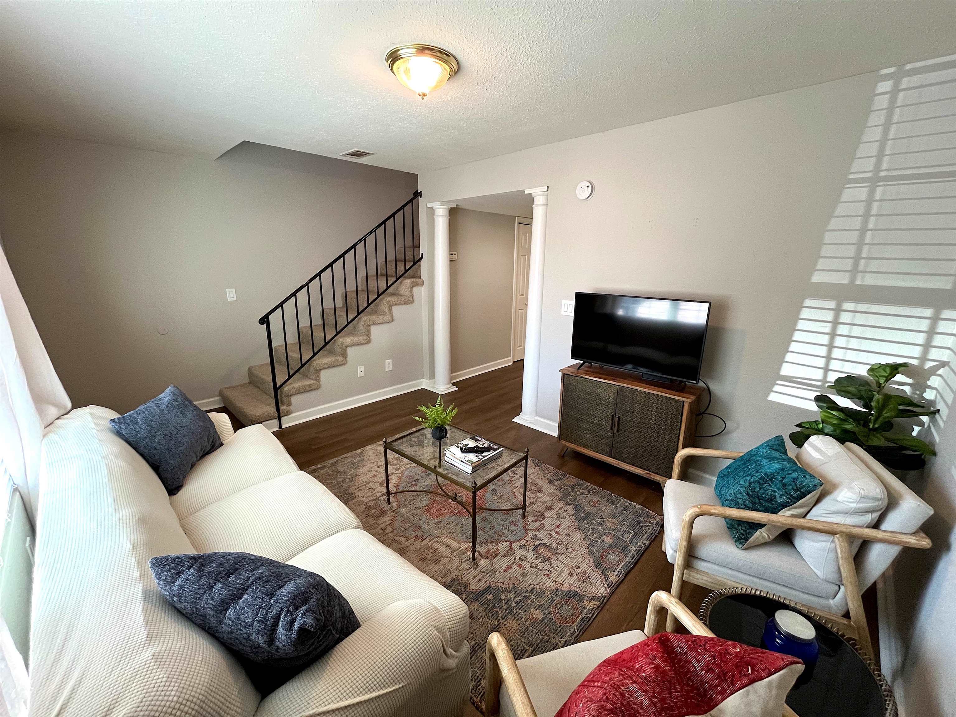 1802 Jackson Avenue West, Unit 20 Oxford, MS 38655 - Photo 1 of 14 a living room with furniture and a flat screen tv
