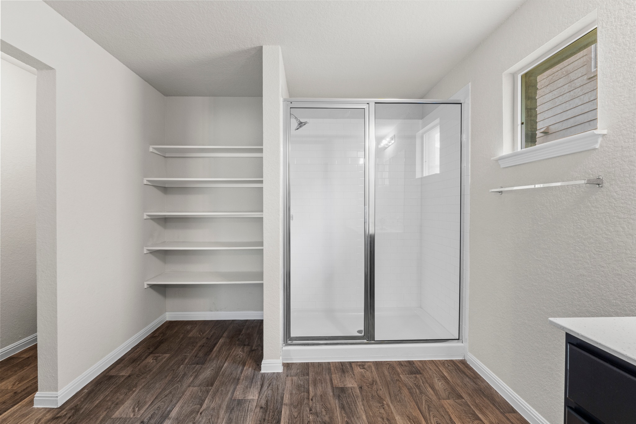 10809 Gonzales Ranger Pass Austin, TX 78754 - Photo 22 of 37 The primary suite also comes with a spacious walk-in shower.