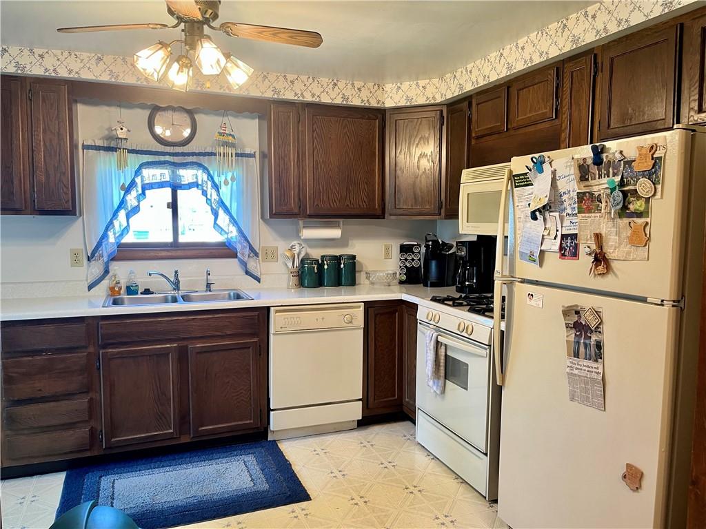 1123 Church Street Indiana, PA 15701 - Photo 5 of 19 a kitchen with a refrigerator a stove a microwave and cabinets