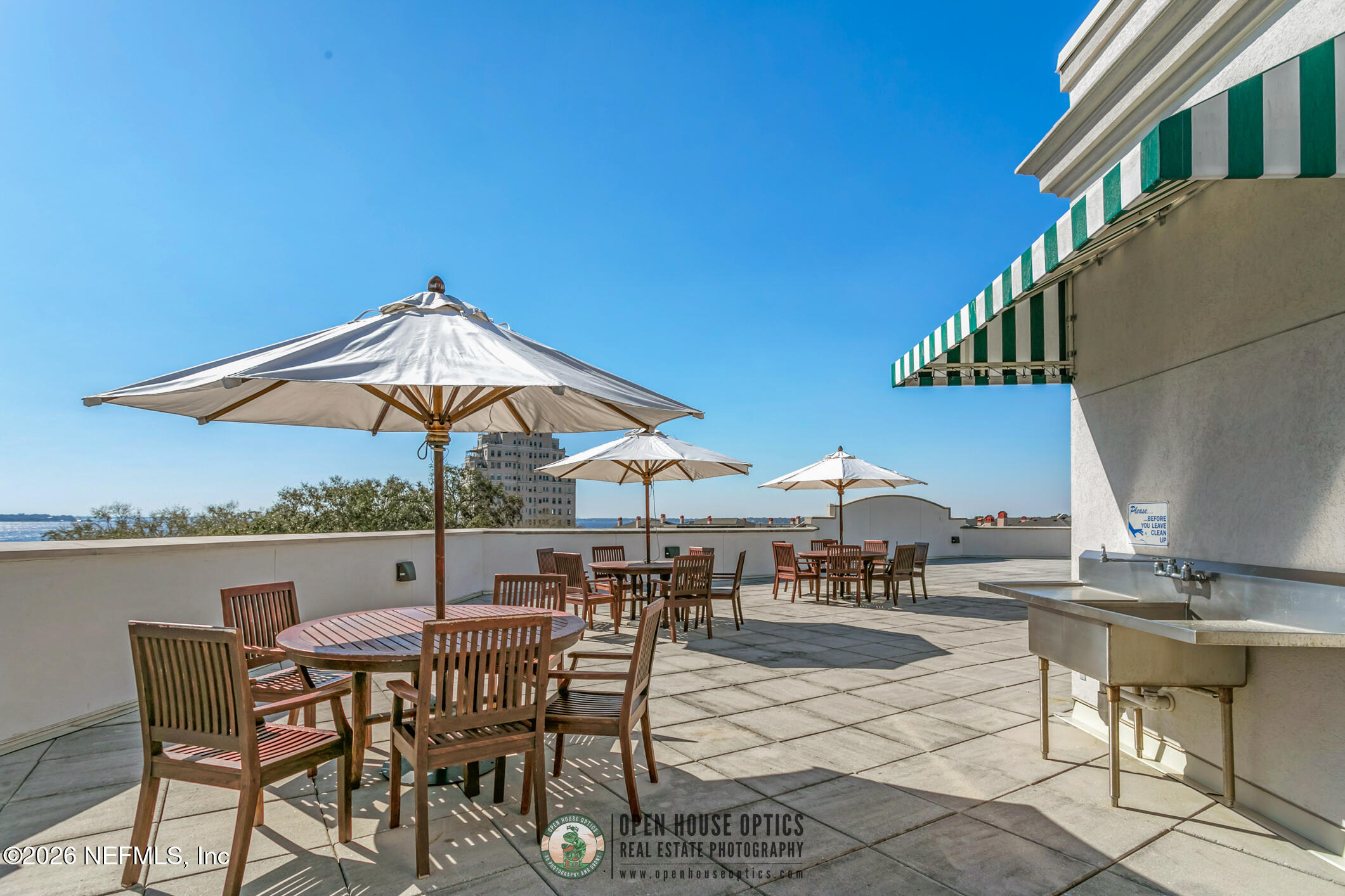 1661 Riverside Avenue, Unit 407 Jacksonville, FL 32204 - Photo 43 of 60 a view of patio with chairs and table under an umbrella