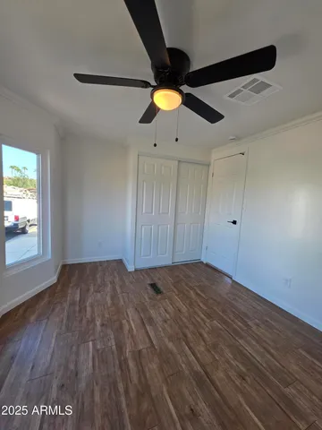 a bathroom with a granite countertop toilet sink and mirror