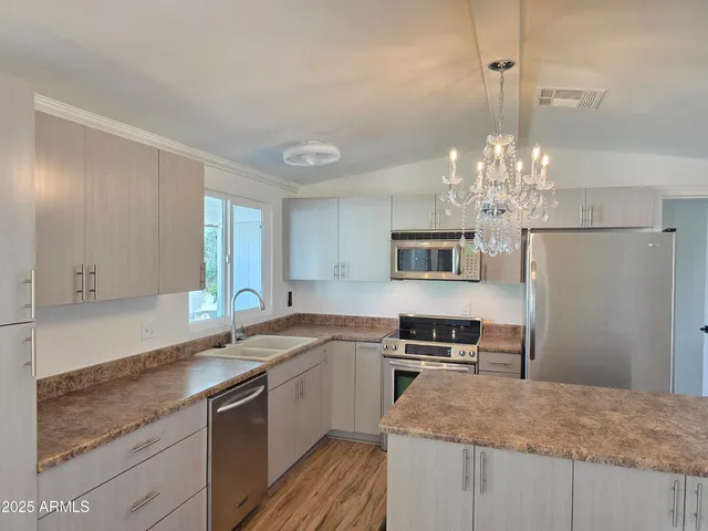 a kitchen with stainless steel appliances granite countertop a stove and cabinets