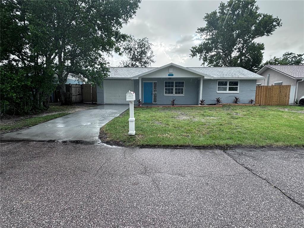 11025 Harding Drive Port Richey, FL 34668 - Photo 1 of 1 a front view of a house with a garden and yard