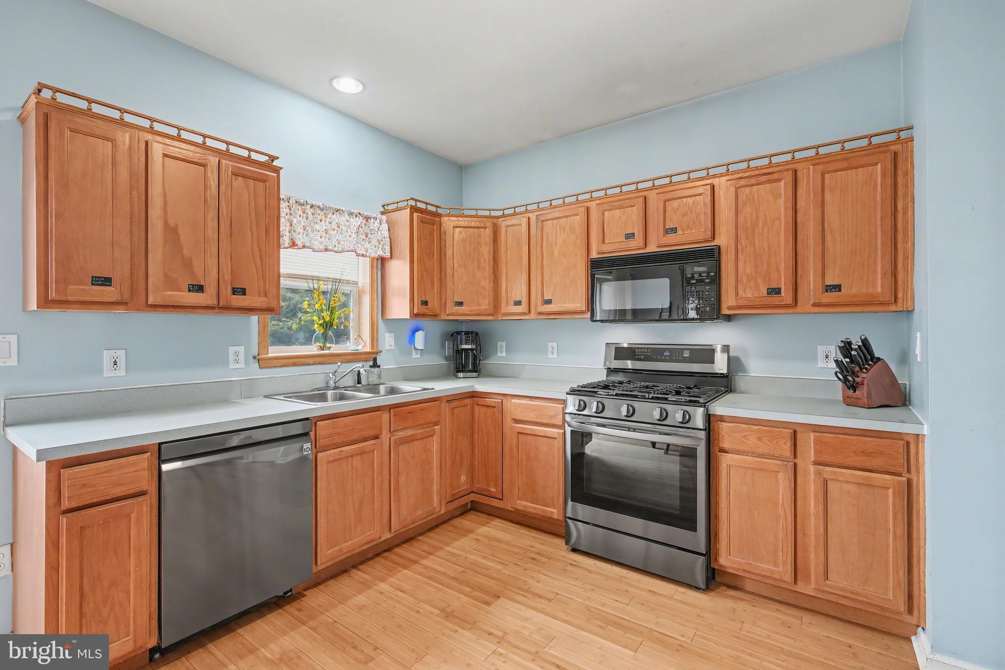 215 Birch Street Hamilton, NJ 08610 - Photo 18 of 38 a kitchen with stainless steel appliances granite countertop wooden cabinets a sink and a stove