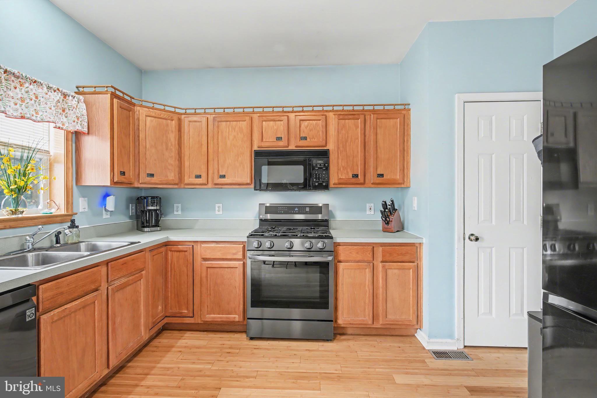 215 Birch Street Hamilton, NJ 08610 - Photo 19 of 38 a kitchen with stainless steel appliances granite countertop a stove and a refrigerator