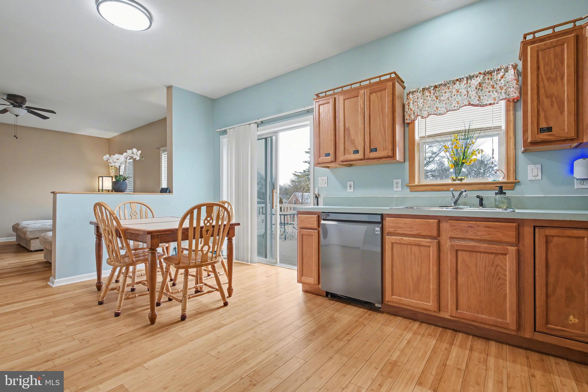 215 Birch Street Hamilton, NJ 08610 - Photo 22 of 38 a kitchen with granite countertop wooden floors cabinets a dining table and chairs