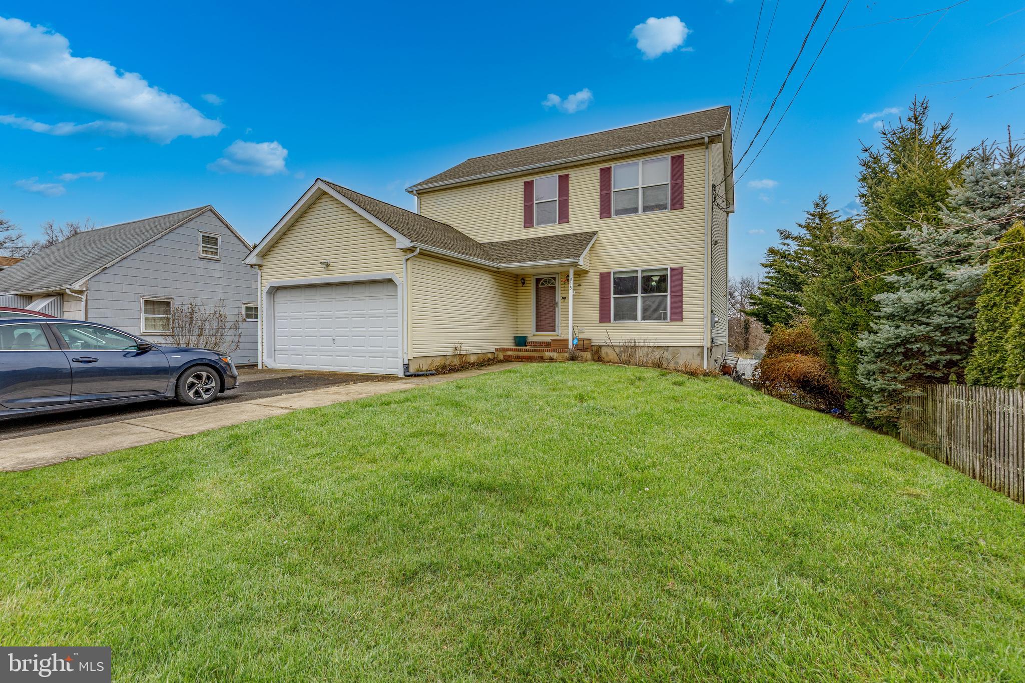 215 Birch Street Hamilton, NJ 08610 - Photo 3 of 38 a front view of a house with a yard and garage