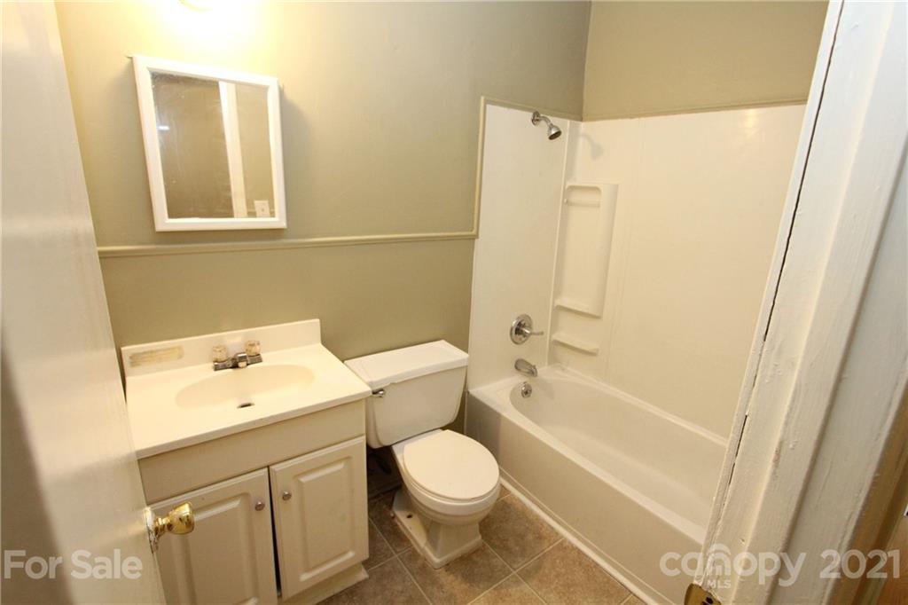 79 Short Town Road Morven, NC 28119 - Photo 14 of 18 a white toilet sitting next to a bathroom sink