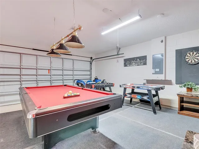a reading room with furniture and air hockey table
