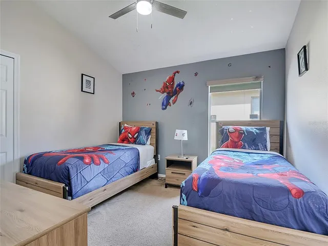 a bedroom with bed and a chandelier