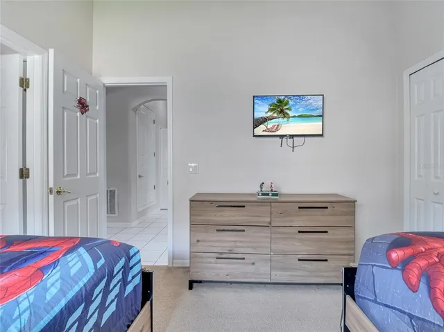 a bedroom with a bed and a dresser