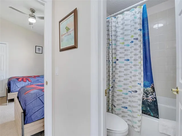 a bathroom with a toilet and shower curtain