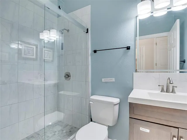 a bathroom with a toilet sink and shower