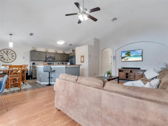 a living room with furniture and kitchen view