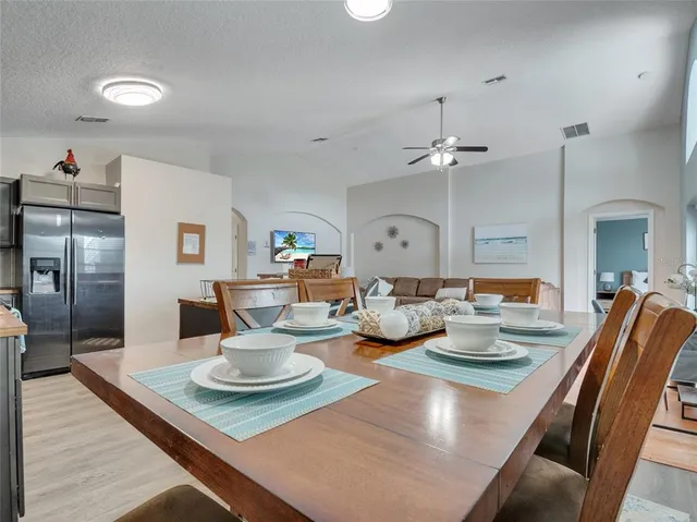 a dining room with furniture and a chandelier