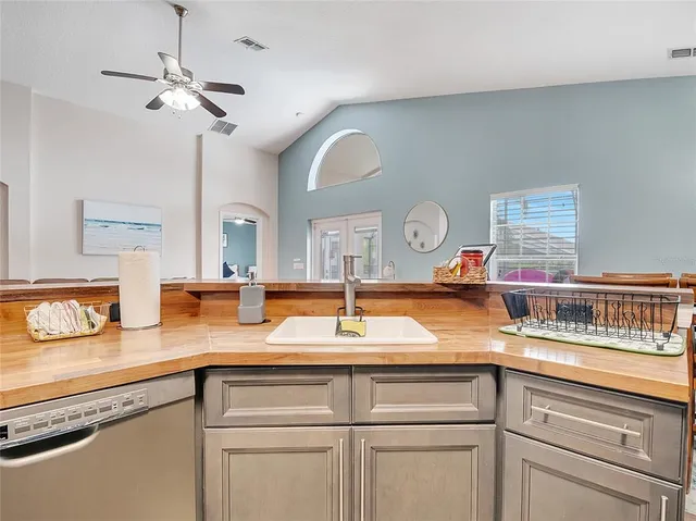 a kitchen with a sink and a clock on the wall