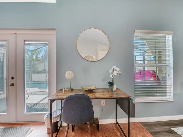 a workspace with furniture a potted plant and a window