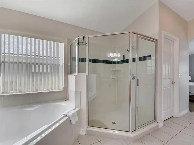 a bathroom with a glass shower door