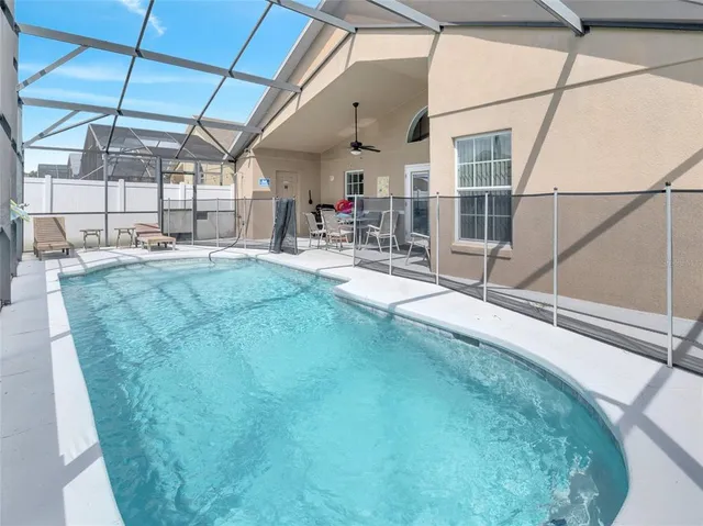 a room with pool table and chairs