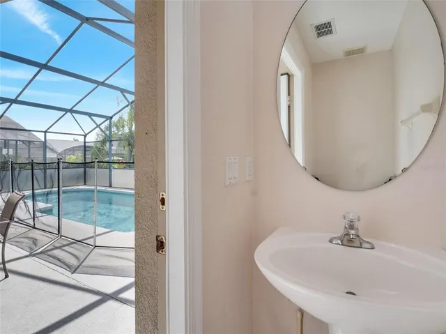 a bathroom with a sink and mirror