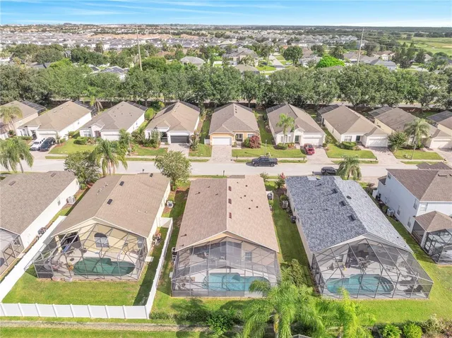 an aerial view of a house with a big yard