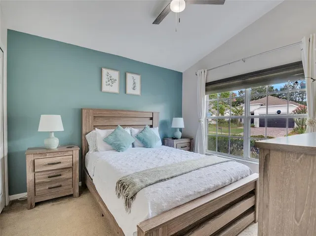 a bedroom with a large bed and a desk