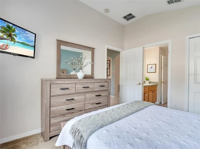 a bedroom with a bed and a dresser