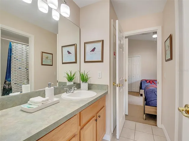 a bathroom with a granite countertop sink a toilet and a mirror