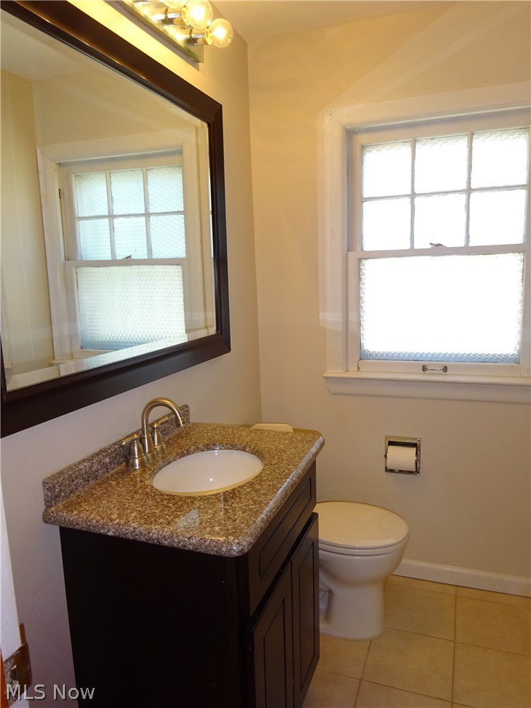 971 Roanoke Road Cleveland, OH 44121 - Photo 10 of 19 Full bath has pretty cherry vanity, gooseneck faucet, and oversized mirror.
