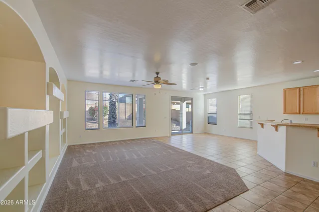 a view of an empty room with a kitchen